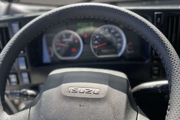 Perforated leather steering wheel wrap stitched onto a truck wheel